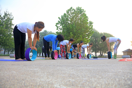 Luannan County - September 8, 2016: women doing yoga exercise   in the park, Luannan County, Hebei Province, China.のeditorial素材