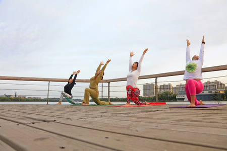 Luannan County - September 17, 2016: Women practicing yoga in the park, Luannan County, Hebei Province, China.のeditorial素材