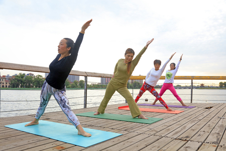 Luannan County - September 17, 2016: yoga exercise women in the park, Luannan County, Hebei Province, China.のeditorial素材