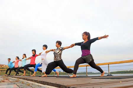Luannan County - September 18, 2016: yoga exercise women in the park, Luannan County, Hebei Province, China.のeditorial素材
