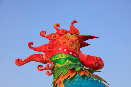 Rooster sculpture in blue backgroundの写真素材