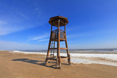 Watchtower on the sea, snow in the blue skyの写真素材