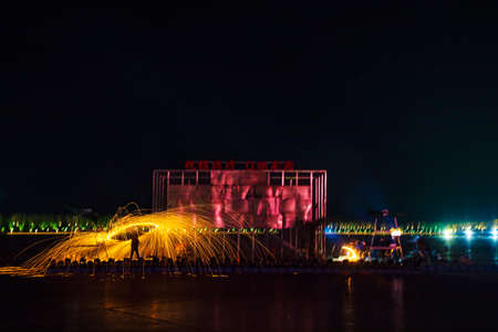 Chinese craftsmen spin hot iron melt at high speed, performing in the darkness, which is a traditional cultural heritageの写真素材