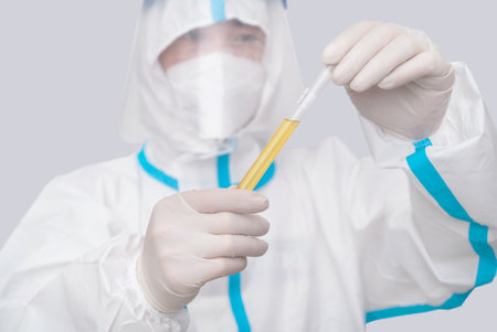 Doctor wearing protective suit doing medical experiment in laboratory, doing nucleic acid test
