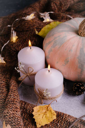 Autumn composition. Pumpkins, candles and knitter sweater.の写真素材
