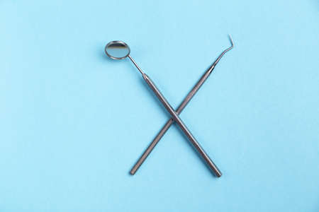 Set of dental instruments on a blue background.の写真素材