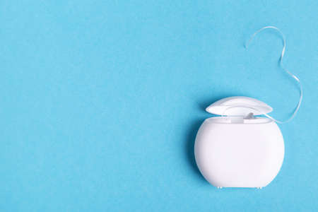 Dental floss on a blue background. Copy space.の写真素材