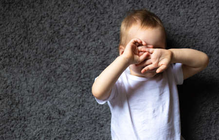 girl closed his eyes with hands to be invisibleの写真素材