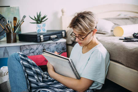 Female artist creates a sketch. Home studio of a creative person.の写真素材