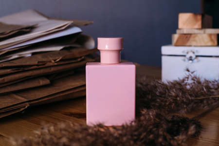 Pink bottle of perfume in an eco setting still life