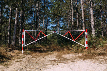 Barrier prohibiting entry into a beautiful pine forest into a private area
