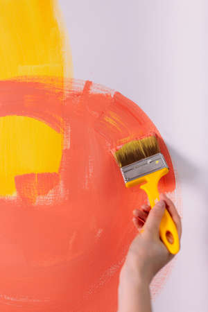 Female hands hold paint brushes. Painting a picture on an easelの写真素材