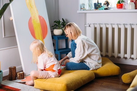 Young woman artist is painting at home in a creative studio setting.の写真素材