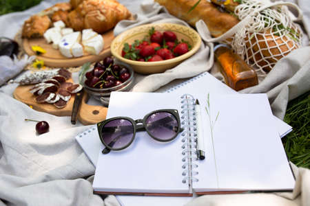 Empty open notepad. Summer paper mockup on the background of bright picnicの写真素材