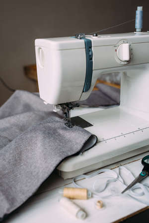 Sewing machine, accessories and fabric. Cozy creative sewing process at homeの写真素材