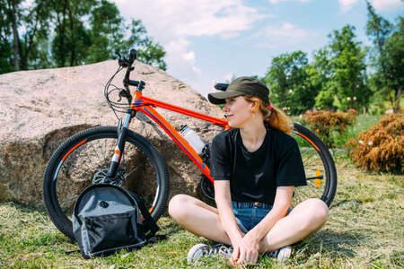 Young attractive woman is resting after bicycle ride. Active lifestyle, sportsの写真素材