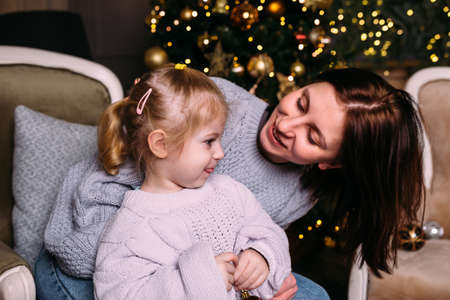 Mother and daughter having fun and relaxing at home. Xmas and New Year conceptの写真素材