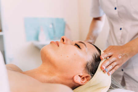 Cosmetologist does facial massage for woman. Beauty skin careの写真素材