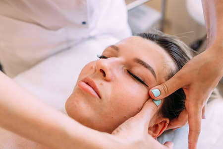Cosmetologist does facial massage for woman. Beauty skin careの写真素材