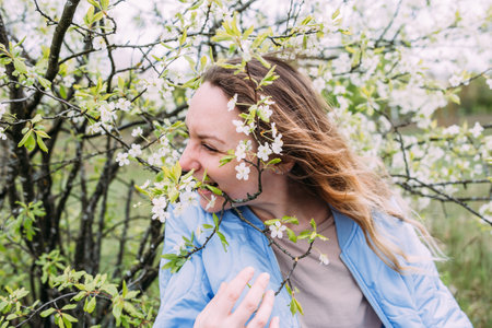 Portrait of a young woman in spring in a park
