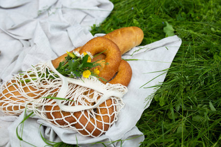 Summer eco-picnic on the grass with an organic linen tablecloth and a bedspread.の写真素材
