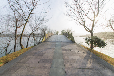 Bridge and river at park in Hangzhou, China.の写真素材
