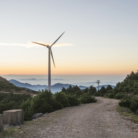 Sunrise, mountain and windmill sceneryの写真素材