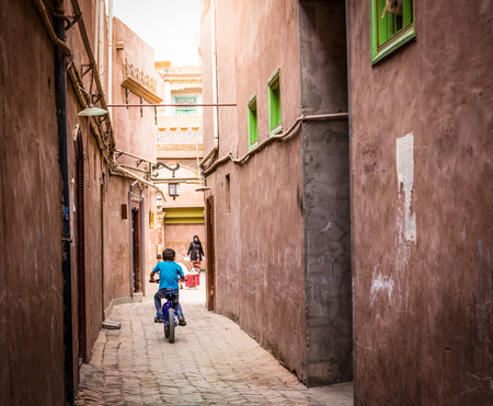 The boy was riding in the alley.のeditorial素材