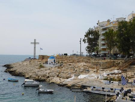 May 2018, Piraeus, Greece. View of the coast with ancient walls, church, and crossのeditorial素材