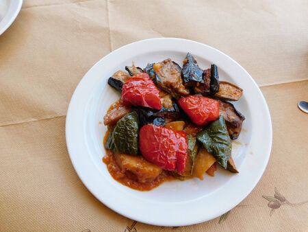 Briam, a Greek cuisine dish, with mixed, roasted vegetables, in olive oilの写真素材
