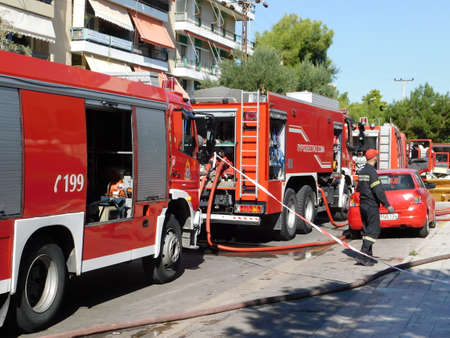 October 1st, 2020, Glyfada, Athens, Greece.  Fire brigade trucks in action, near a burning shop