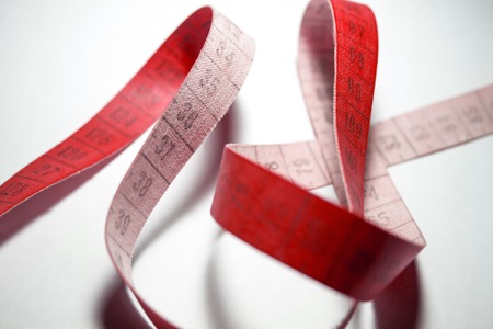 Entangled measuring tape. Measuring meter Red colorの写真素材
