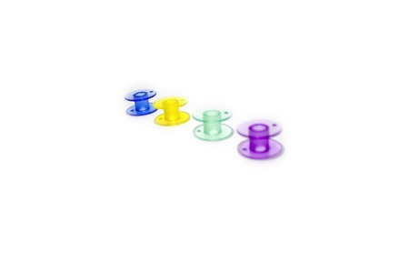 Colored bobbins for machine sewing isolated on white background