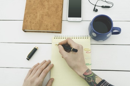 Luxury means of a businessman on a wooden table man with tattoosの写真素材