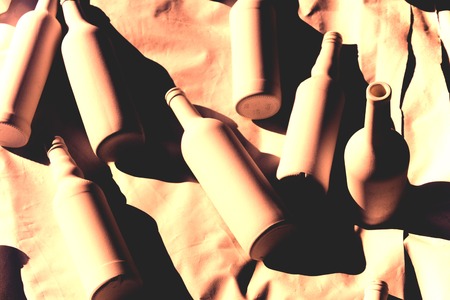 Different wine vodka bottles covered with white acrylic paint. On a white background. Black and white photo. Dark red effect. Excellent bar background. Creative decor. Secured by modern style.の写真素材