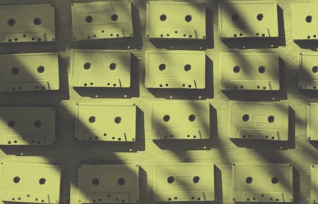 Audio cassettes are covered with white acrylic paint. Excellent retro. Creative decor. Sepia effect. Secured by modern style. Vintage tapes.の写真素材