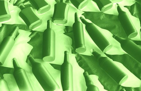 Different wine vodka bottles covered with white acrylic paint. On a white background. Black and white photo. Negative green effect. Excellent bar background. Creative decor. Secured by modern style.の写真素材