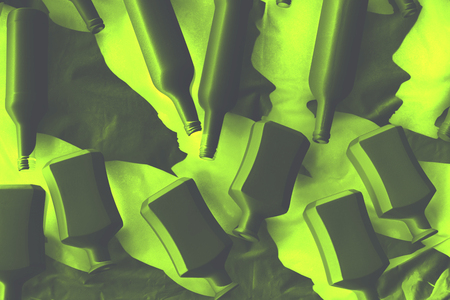 Different wine vodka bottles covered with white acrylic paint. On a white background. Black and white photo. Negative yellow green effect. Excellent bar background. Creative decor. Secured by modern style.の写真素材