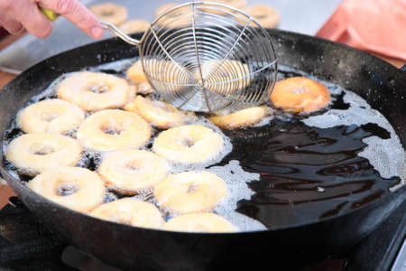 Doughnuts frying in oil