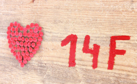 Reddish heart on woodの写真素材