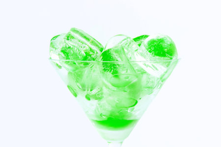Cup with green ice cubesの写真素材
