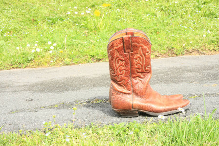 Cowboy boot on the roadの写真素材