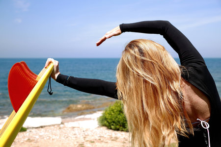 Surfer woman stretching-Franceの写真素材