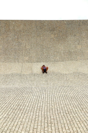 BIARRITZ, FRANCE - JULY 28, 2014: Man takes a rest over cobblestone in the City of the ocean facility on July 28, in Biarritz-France.のeditorial素材