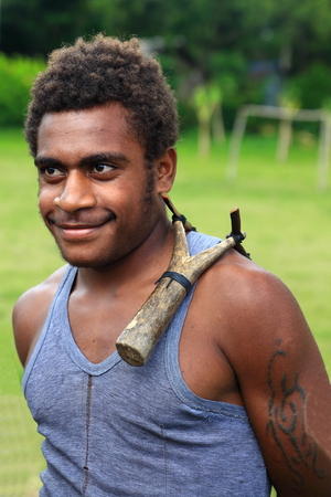 Ambrym, VANUATU-OCTOBER 11, 2014: Attractive young student plays with His slingshot at playground on October 11, in Harimal-Vanuatu.のeditorial素材