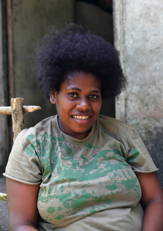 PENTECOSTES, VANUATU-OCTOBER 12, 2014: Local woman with afro hair hairdressing expected turn in the village on October 12, in Pangi-Vanuatu.のeditorial素材