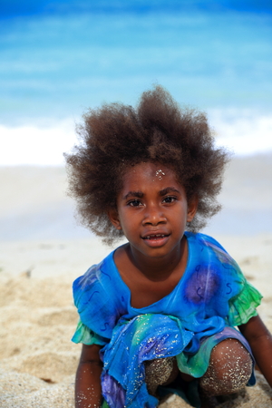 HOLY SPIRIT, VANUATU-OCTOBER 19, 2014: Ni-Vanuatu Local girl shows the fashion in hair cutting while playing on the beach on October 19, in Port Olry-Vanuatu.のeditorial素材
