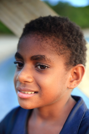 PANGI,VANUATU-OCTOBER 14, 2014: Native girl takes care of her brother while their parents work in a local business on October 14, in Pentecostes-Vanuatu.のeditorial素材