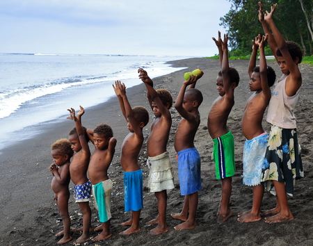 AMBRYM,VANUATU-OCTOBER 10, 2014: Eleven kids playing on the beach while their parents work in the village shop on October 10, in Olal-Vanuatu.のeditorial素材