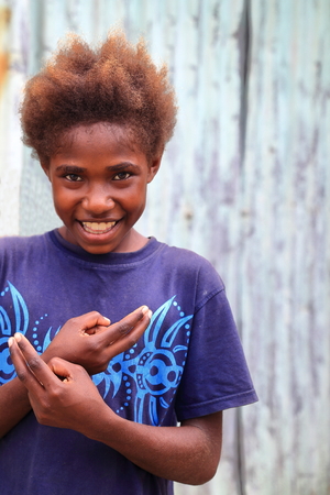 EPI,VANUATU-OCTOBER 5, 2014: Pretty girl poses for the photographer at the entrance to her home on October 5, in Nikaura-Vanuatu.のeditorial素材